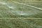 Sprinklers Automatic lawn grass irrigation system in stadium. Football, soccer field in small provincial town. Underground