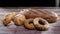 Sprinkling flour on organic rye brad and buns and bagels on the table