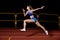 Sprinter girl jumps on track running training