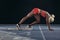 Sprinter using a starting block to start her sprint on a running