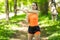 Sprinter woman doing warm-up exercises before run on stadium track with red coating outdoor