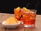 Spritz aperitif - two orange cocktail with ice cubes