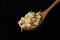 Sprout  chickpeas in wooden spoon on black background