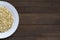 Sprouted buckwheat on half of white plate with copy space