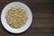 Sprouted buckwheat on white plate with copy space - Left position