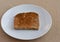 Sprouted grain toast on a white plate