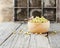 Sprouted veggie seeds in a wooden bowl on a rustic table, selective focus