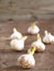 Sprouted white garlic on an old textured wooden table. Ready for planting in the ground. Rural spring work