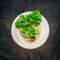 Sprouting celery root in the cup of water later to be planted in the soil