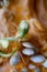 Sprouting pumpkin seeds and fibrous strands within cut pumpkin. Close-up