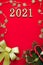 Spruce branches, snowflake garland candies on a red background. Flat lay, top view, copy space. christmas 2021