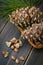 Spruce resinous pine-cones in wicker basket with pine nuts and p