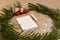 Spruce wreath with a red car with a bag of gifts, on the table framing white notebook and pencil crayon near snow chips.