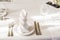 Spun white napkins on a plate on a served table. Plate in a cafe or restaurant with a napkin and appliances