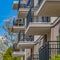 Square Balconies of a residential building against blue sky and snowy mountain