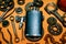 Square black flask in the center of rusty tools, gears on background. Motorcycle equipment and repair template