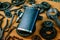 Square black flask in the center of rusty tools, gears on background. Motorcycle equipment and repair template