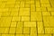 Square blocks paving background toned in yelllow