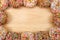 Square border of sprinkle donuts on wood table