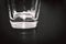 Square Bottom of Empty Beer Glass on Dark Table Surface. Bubbles Left from the Beer Head or Collar, Frothy Foam on Top of the