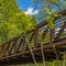 Square Bridge with metal guardrails over the glistening water at Ogden River Parkway