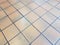 Square brown or orange floor tiles on ground