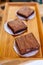 Square Brownie Chocolate Cakes on wooden tray that ready to sell. Melt in your mouth