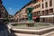 Square with buildings, restaurant and fountain, in ChambÃ©ry.