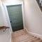 Square Carpeted U shaped staircase that leads down to the basement door of a home