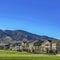 Square Charming homes and towering mountain under clear blue on a sunny day