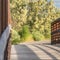 Square Close up of a bridge with metal guardrail and wood deck on a sunny day