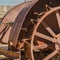 Square Close up of the damaged wheels of an old vintage tractor against sunny blue sky