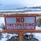 Square Close up of No Trespassing signage with snowy Utah Lake background in winter