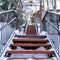 Square Close up of stairway on snow covered slope with buildings and trees background