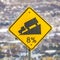 Square Close up of a yellow road grade sign with a truck on slope illustration