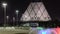 Square with colorful fountain at night near the Palace of Peace and Reconciliation building timelapse in Astana