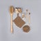 Square composition with zero waste bathroom essentials on grey background - bamboo toothbrushes, cotton buds, wooden body brush,