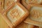 Square crackers, cookies with vintage samovar image close up