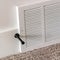Square crop Air conditioner white plastic grille cover against wall and carpet floor