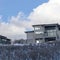 Square crop Blue sky and puffy clouds over homes on an inceredible mountain setting in winter