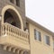 Square crop Exterior of apartment with moulded white balustrade on the arched balcony