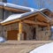 Square crop Home in Park City Utah with snowy gable roofs stone wall and outdoor stairs