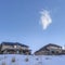 Square crop Houses surrounded by sweeping views of snow covered Wasatch Mountain landscape