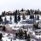 Square crop Tall evergreens and luxurious homes on snowy mountain neighborhood in Park City