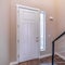 Square crop White hinged wooden front door and sidelight viewed from inside of home