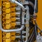 Square Details of the engine of a yellow heavy duty construction vehicle
