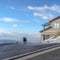 Square Dog on the driveway of a home overlooking Wasatch Mountain and cloudy blue sky