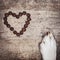 Square, DogÂ´s paw and dried heart-shaped kibble on wooden table