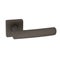 Square door handle in matt graphite color with a yellowish tint on a split base