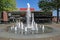 Square in dutch town with water fountain and modern municipal theater building